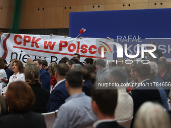 In Krakow, Poland, on November 16, 2024, people with a banner and hats with the inscription 'Mentzen 2025' disrupt the event during a meetin...