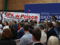 In Krakow, Poland, on November 16, 2024, people with a banner and hats with the inscription 'Mentzen 2025' disrupt the event during a meetin...