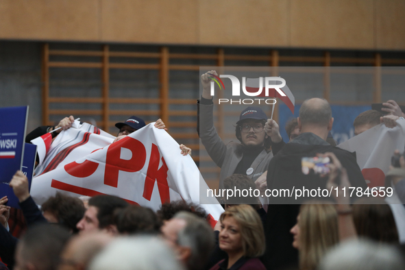 In Krakow, Poland, on November 16, 2024, people with a banner and hats with the inscription 'Mentzen 2025' disrupt the event during a meetin...