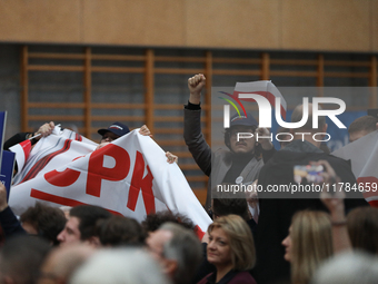 In Krakow, Poland, on November 16, 2024, people with a banner and hats with the inscription 'Mentzen 2025' disrupt the event during a meetin...