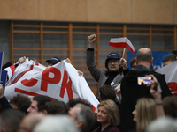 In Krakow, Poland, on November 16, 2024, people with a banner and hats with the inscription 'Mentzen 2025' disrupt the event during a meetin...