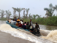 Residents in a boat in Ugbonla, Ilaje, Local Government Area, Ondo State, Nigeria, head to their polling unit during the 2024 Governorship e...