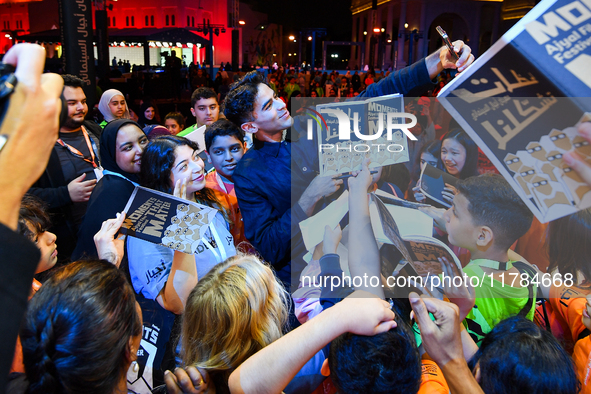 Nadir Nahdi takes selfies with fans during the ''Sudan, Remember Us'' screening on the opening night of the Ajyal Film Festival 2024 present...