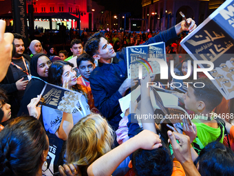 Nadir Nahdi takes selfies with fans during the ''Sudan, Remember Us'' screening on the opening night of the Ajyal Film Festival 2024 present...