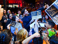 Nadir Nahdi takes selfies with fans during the ''Sudan, Remember Us'' screening on the opening night of the Ajyal Film Festival 2024 present...