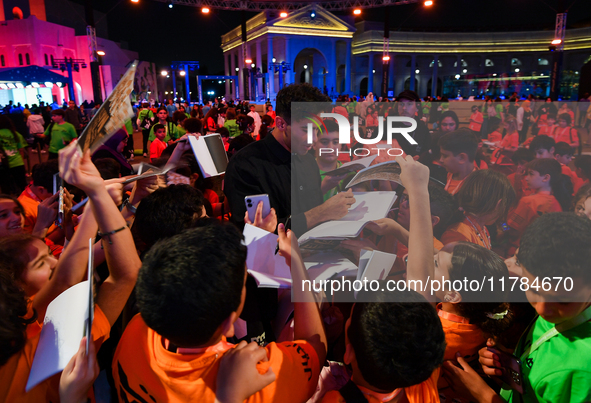 Nadir Nahdi signs autographs for fans during the ''Sudan, Remember Us'' screening on the opening night of the Ajyal Film Festival 2024 prese...