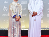 Fatma Al Remaihi, CEO of the Doha Film Institute, and Abdulla Yousef Al Mulla attend the ''Sudan, Remember Us'' red carpet during the screen...