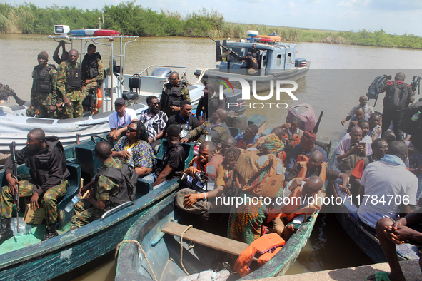 Journalists and security personnel depart a jetty after covering election processes during the 2024 Governorship election for Ondo State in...