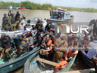 Journalists and security personnel depart a jetty after covering election processes during the 2024 Governorship election for Ondo State in...