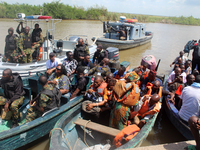 Journalists and security personnel depart a jetty after covering election processes during the 2024 Governorship election for Ondo State in...