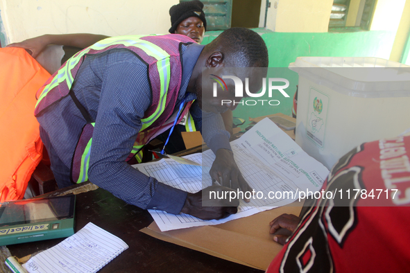 An INEC official writes election results at Ward 2, Unity 6 during the 2024 Governorship election for Ondo State in Ugbonla, Ilaje, Local Go...