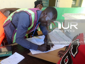 An INEC official writes election results at Ward 2, Unity 6 during the 2024 Governorship election for Ondo State in Ugbonla, Ilaje, Local Go...