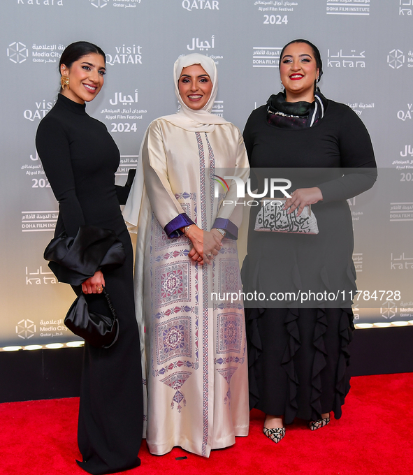 Fatma Al Remaihi, CEO of the Doha Film Institute, poses with a guest on the red carpet during the ''Sudan, Remember Us'' screening on the op...