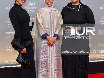 Fatma Al Remaihi, CEO of the Doha Film Institute, poses with a guest on the red carpet during the ''Sudan, Remember Us'' screening on the op...