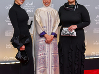 Fatma Al Remaihi, CEO of the Doha Film Institute, poses with a guest on the red carpet during the ''Sudan, Remember Us'' screening on the op...