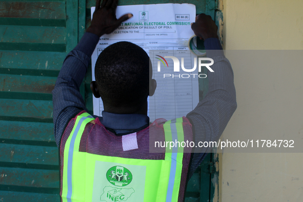 An INEC official pastes election results at Ward 2, Unity 6 during the 2024 Governorship election for Ondo State in Ugbonla, Ilaje, Local Go...