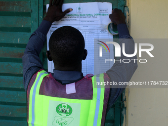 An INEC official pastes election results at Ward 2, Unity 6 during the 2024 Governorship election for Ondo State in Ugbonla, Ilaje, Local Go...