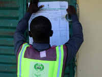 An INEC official pastes election results at Ward 2, Unity 6 during the 2024 Governorship election for Ondo State in Ugbonla, Ilaje, Local Go...