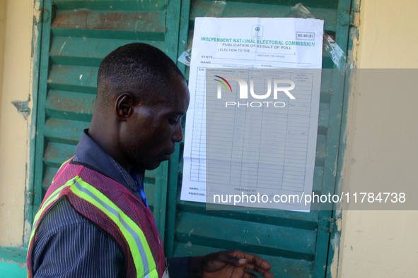 An INEC official pastes election results at Ward 2, Unity 6 during the 2024 Governorship election for Ondo State in Ugbonla, Ilaje, Local Go...