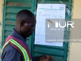 An INEC official pastes election results at Ward 2, Unity 6 during the 2024 Governorship election for Ondo State in Ugbonla, Ilaje, Local Go...