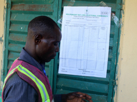 An INEC official pastes election results at Ward 2, Unity 6 during the 2024 Governorship election for Ondo State in Ugbonla, Ilaje, Local Go...