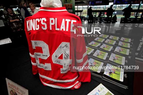 A collectible hockey jersey with the signatures of the 2024 King's Plate jockeys is on view during a raffle to raise funds for LongRun Thoro...