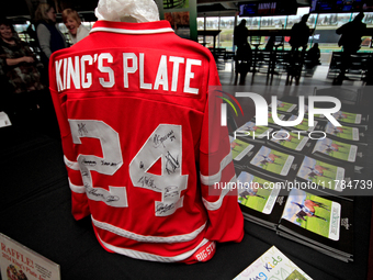 A collectible hockey jersey with the signatures of the 2024 King's Plate jockeys is on view during a raffle to raise funds for LongRun Thoro...