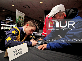 Jockey Fraser Aebly signs autographs to help raise funds for LongRun Thoroughbred Retirement Society, an organization that takes retired rac...