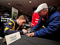 Jockey Fraser Aebly signs autographs to help raise funds for LongRun Thoroughbred Retirement Society, an organization that takes retired rac...