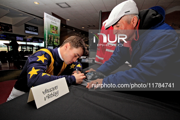 Jockey Fraser Aebly signs autographs to help raise funds for LongRun Thoroughbred Retirement Society, an organization that takes retired rac...