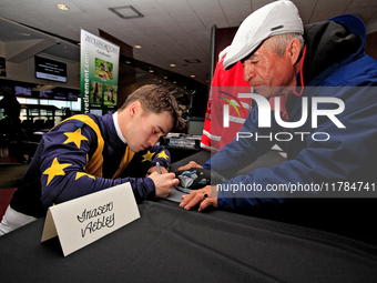 Jockey Fraser Aebly signs autographs to help raise funds for LongRun Thoroughbred Retirement Society, an organization that takes retired rac...