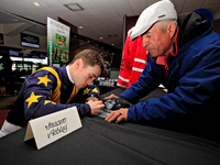 Jockey Fraser Aebly signs autographs to help raise funds for LongRun Thoroughbred Retirement Society, an organization that takes retired rac...