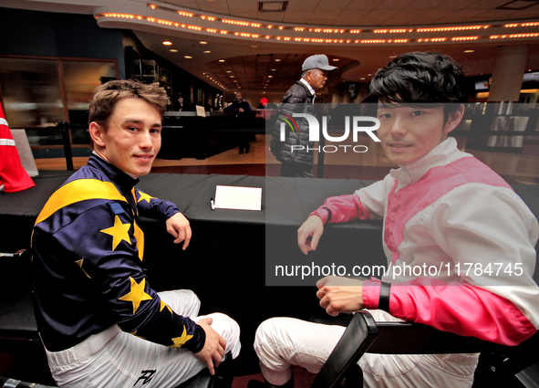 Jockeys Fraser Aebly, left, and Daisuke Fukumoto sign autographs to help raise funds for LongRun Thoroughbred Retirement Society, an organiz...