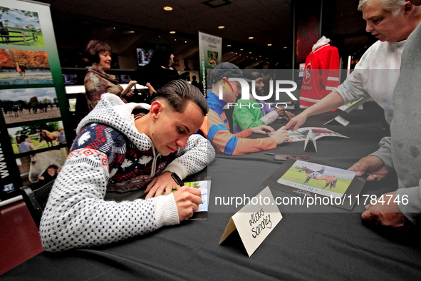 Jockey Alexis Sanchez signs autographs to help raise funds for LongRun Thoroughbred Retirement Society, an organization that takes retired r...