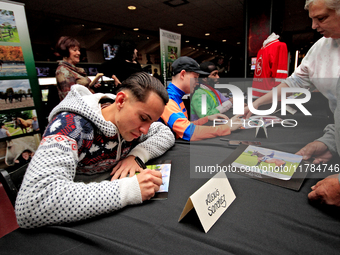 Jockey Alexis Sanchez signs autographs to help raise funds for LongRun Thoroughbred Retirement Society, an organization that takes retired r...