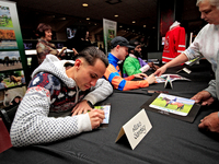 Jockey Alexis Sanchez signs autographs to help raise funds for LongRun Thoroughbred Retirement Society, an organization that takes retired r...