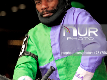 Jockey Juan Crawford rides out of the paddock for the second race at Woodbine Racetrack in Toronto, Canada, on November 16, 2024. (