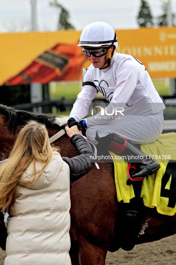 Jockey Austin Adams receives a handshake from connections of Sailor's Passion after a win in the fourth race at Woodbine Racetrack in Toront...