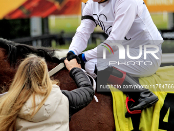 Jockey Austin Adams receives a handshake from connections of Sailor's Passion after a win in the fourth race at Woodbine Racetrack in Toront...