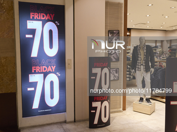 Promotional signage advertises up to 70% off for Black Friday at a clothing store in Molfetta, Italy, on November 17, 2024. The image highli...