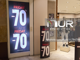 Promotional signage advertises up to 70% off for Black Friday at a clothing store in Molfetta, Italy, on November 17, 2024. The image highli...