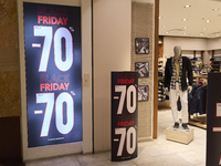 Promotional signage advertises up to 70% off for Black Friday at a clothing store in Molfetta, Italy, on November 17, 2024. The image highli...