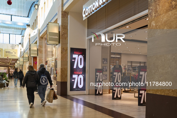 Promotional signage advertises up to 70% off for Black Friday at a clothing store in Molfetta, Italy, on November 17, 2024. The image highli...