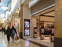 Promotional signage advertises up to 70% off for Black Friday at a clothing store in Molfetta, Italy, on November 17, 2024. The image highli...