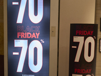 Promotional signage advertises up to 70% off for Black Friday at a clothing store in Molfetta, Italy, on November 17, 2024. The image highli...