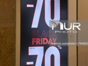 Promotional signage advertises up to 70% off for Black Friday at a clothing store in Molfetta, Italy, on November 17, 2024. The image highli...