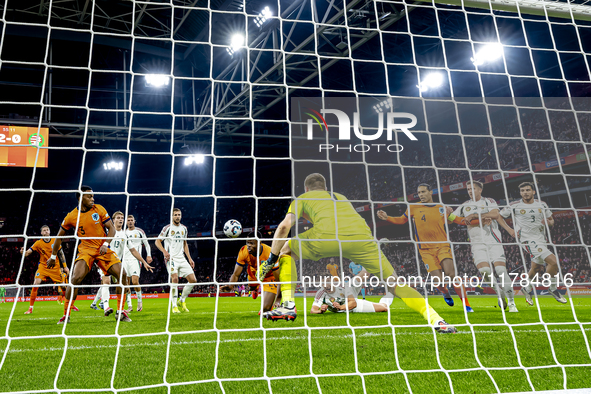 Netherlands defender Denzel Dumfries, Hungary midfielder Tamas Nikitscher, and Netherlands defender Virgil van Dijk participate in the match...