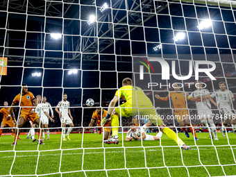 Netherlands defender Denzel Dumfries, Hungary midfielder Tamas Nikitscher, and Netherlands defender Virgil van Dijk participate in the match...