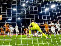 Netherlands defender Denzel Dumfries, Hungary midfielder Tamas Nikitscher, and Netherlands defender Virgil van Dijk participate in the match...