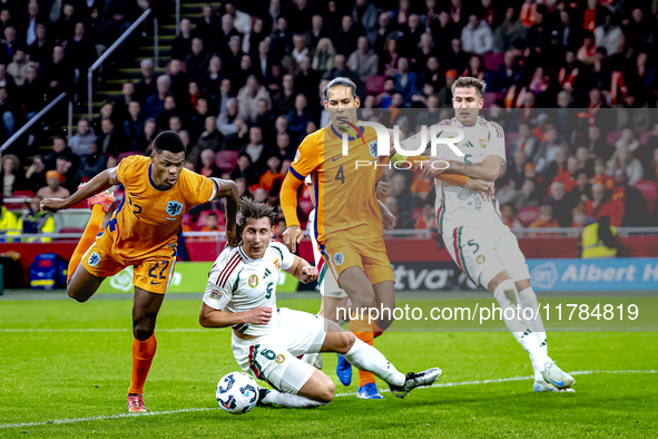 Netherlands defender Denzel Dumfries, Hungary midfielder Tamas Nikitscher, and Netherlands defender Virgil van Dijk participate in the match...